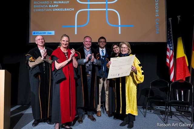 Dr. Rapp receiving a doctoral certificate from a group of UC Louvain officials. 